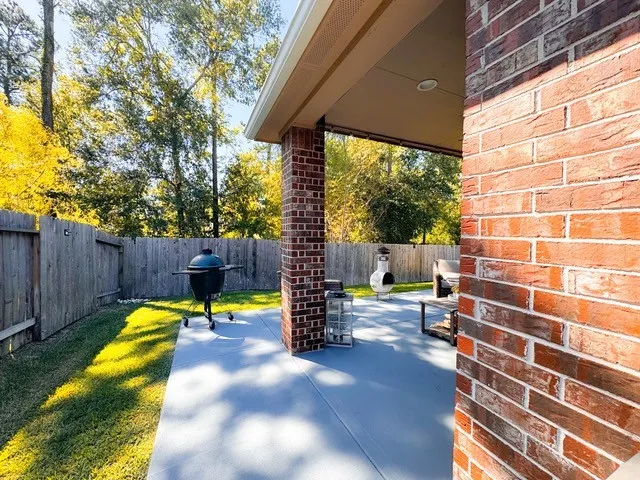 a swimming pool with outdoor seating and yard