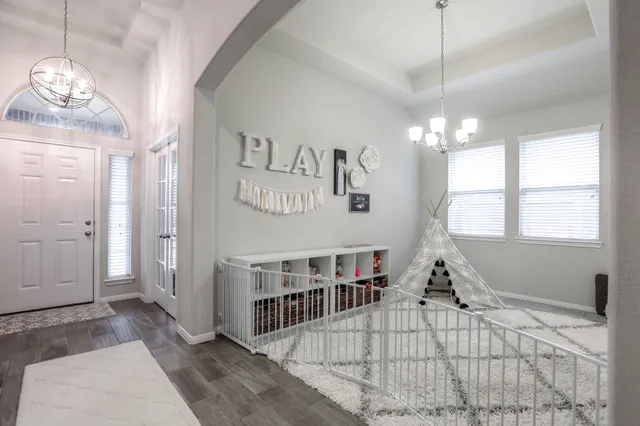 a bedroom with furniture and a chandelier