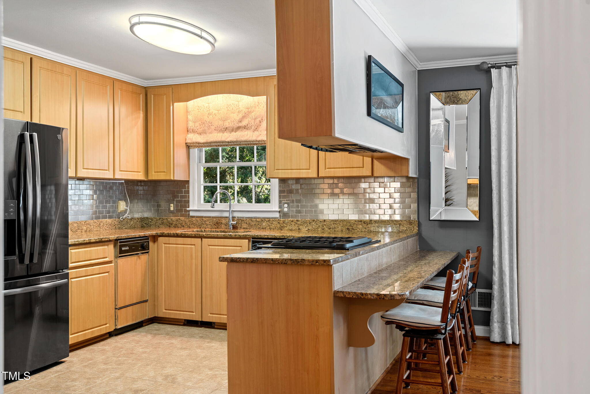 3404 Oates Drive Raleigh, NC 27604 - Photo 14 of 43 a kitchen with stainless steel appliances granite countertop a stove a sink and a refrigerator