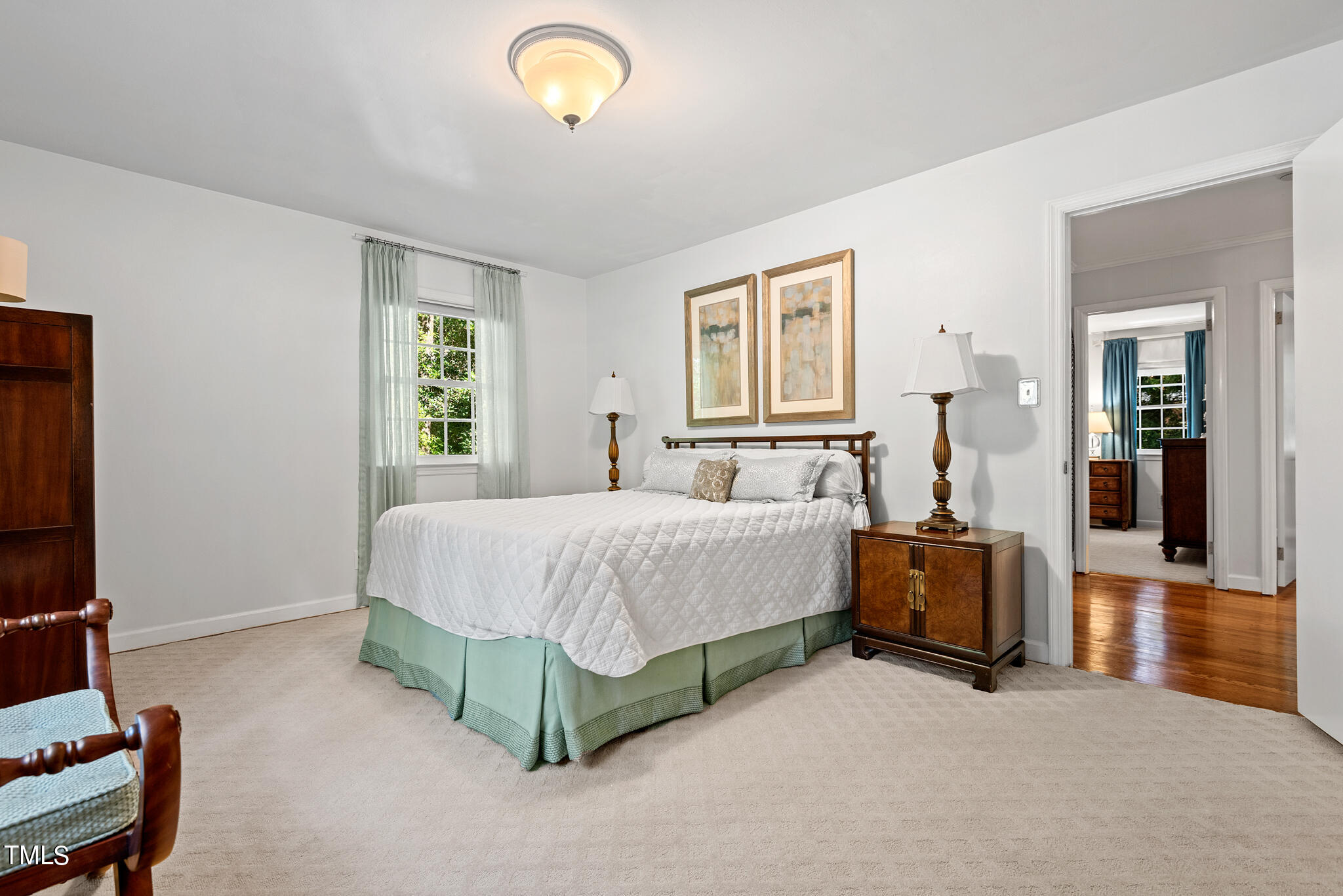 3404 Oates Drive Raleigh, NC 27604 - Photo 18 of 43 a spacious bedroom with a bed and a couch