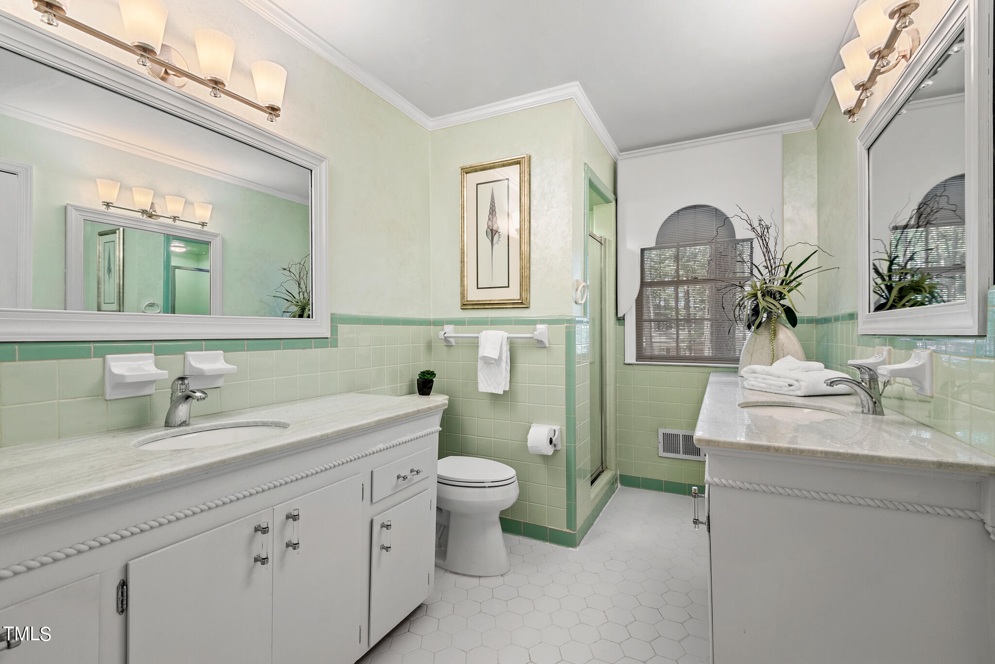 3404 Oates Drive Raleigh, NC 27604 - Photo 20 of 43 a spacious bathroom with a toilet sink and mirror