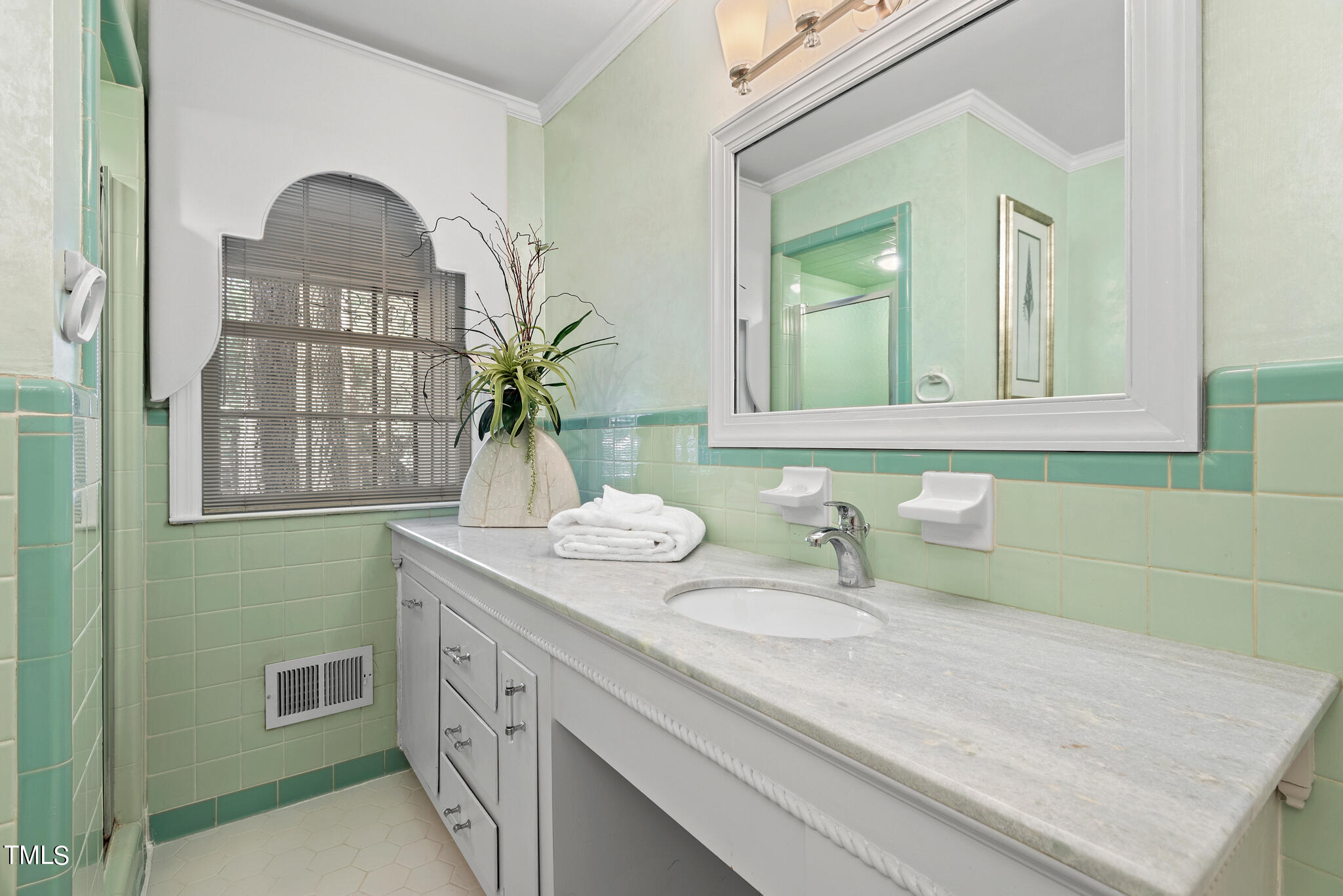 3404 Oates Drive Raleigh, NC 27604 - Photo 21 of 43 a bathroom with a sink and a mirror