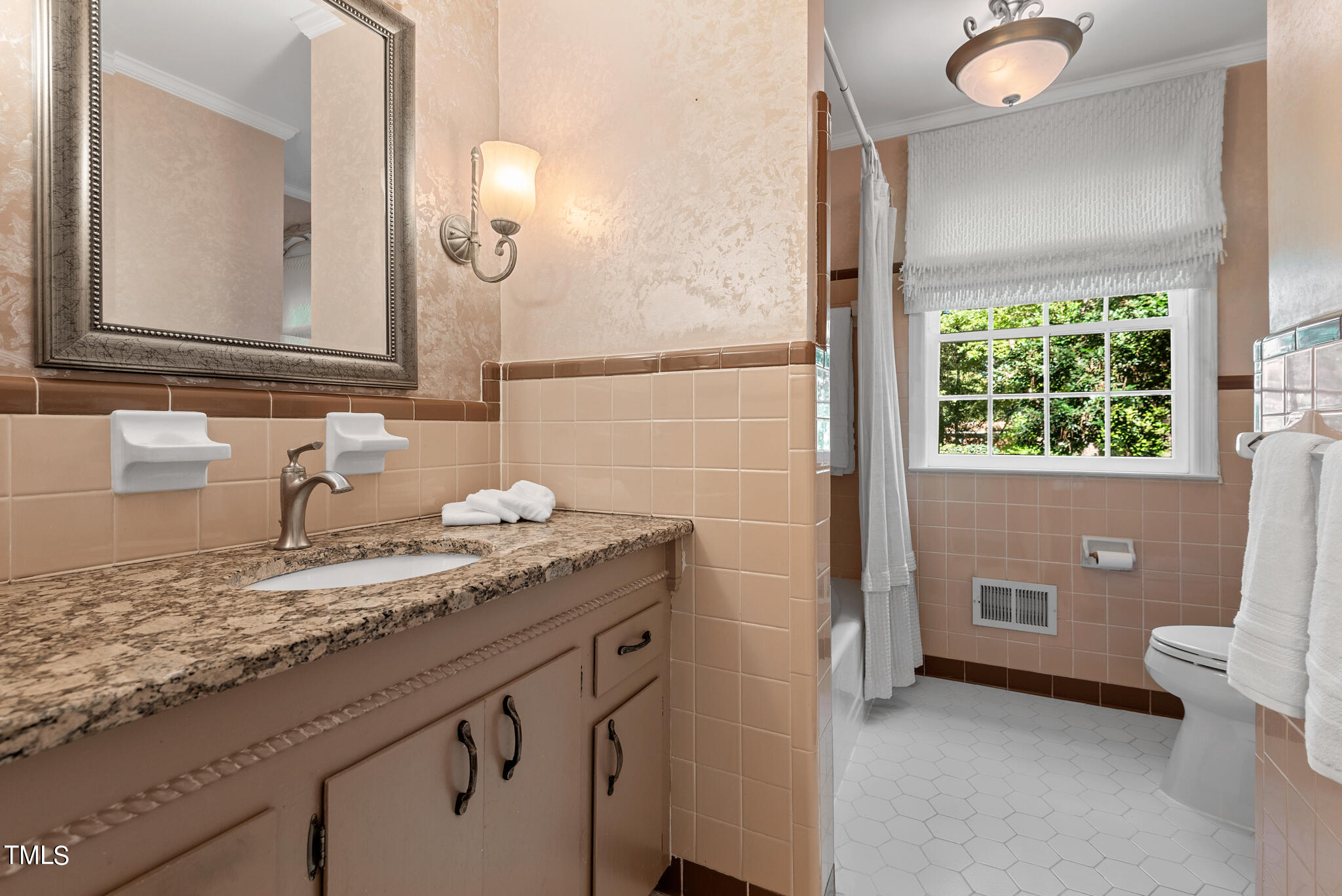 3404 Oates Drive Raleigh, NC 27604 - Photo 25 of 43 a bathroom with a granite countertop sink a toilet and a mirror