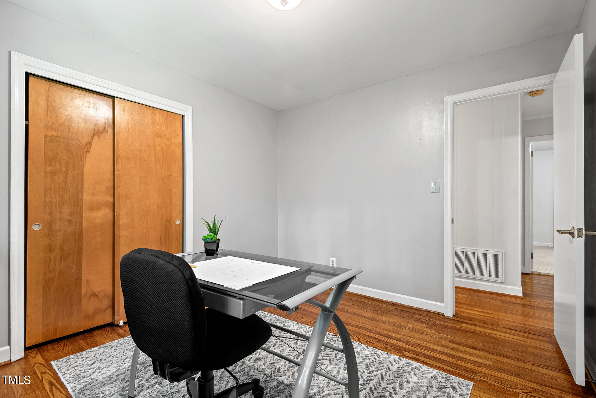 3404 Oates Drive Raleigh, NC 27604 - Photo 28 of 43 a view of a workspace with furniture and wooden floor