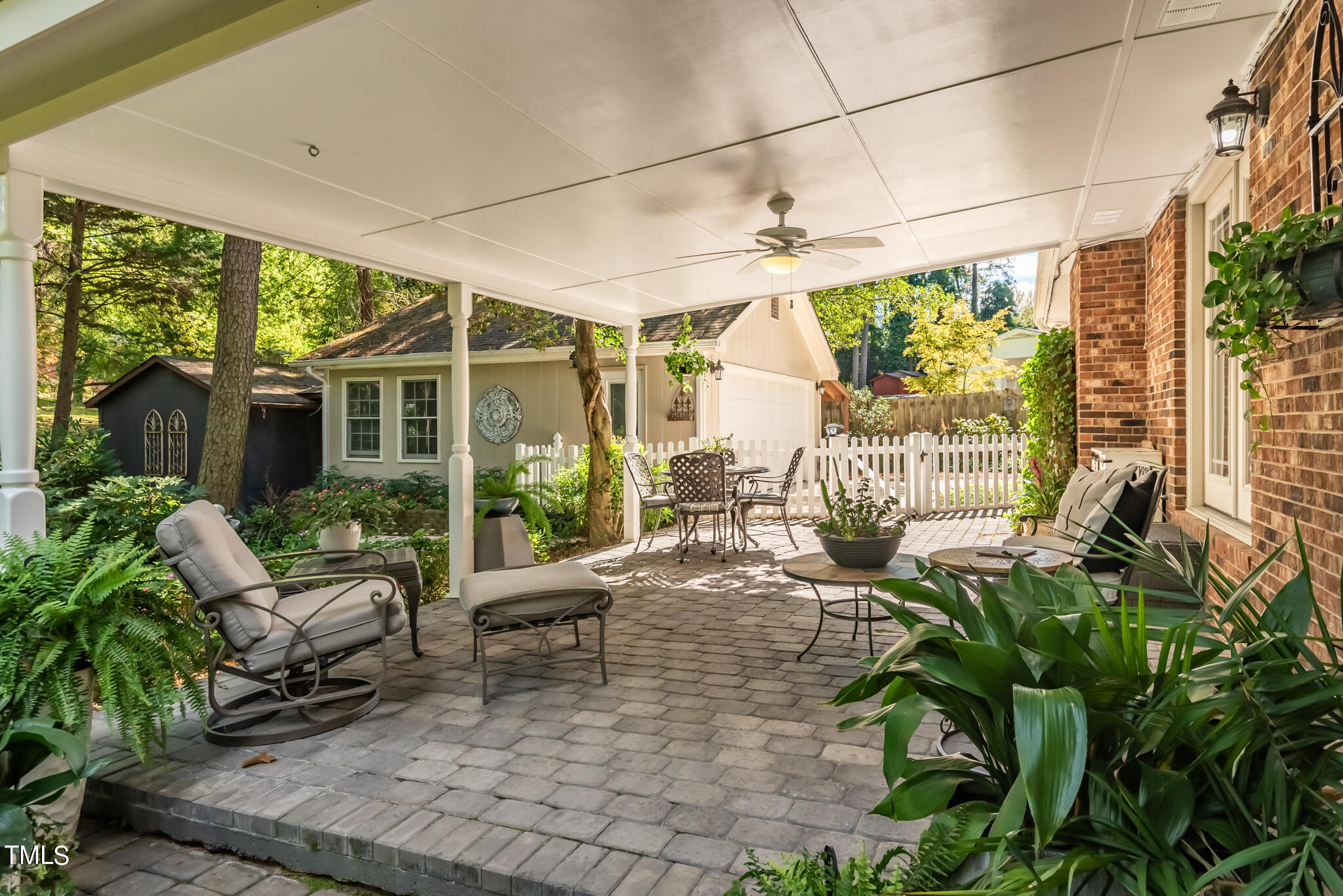 3404 Oates Drive Raleigh, NC 27604 - Photo 35 of 43 a view of a patio with table and chairs potted plants and floor to ceiling window