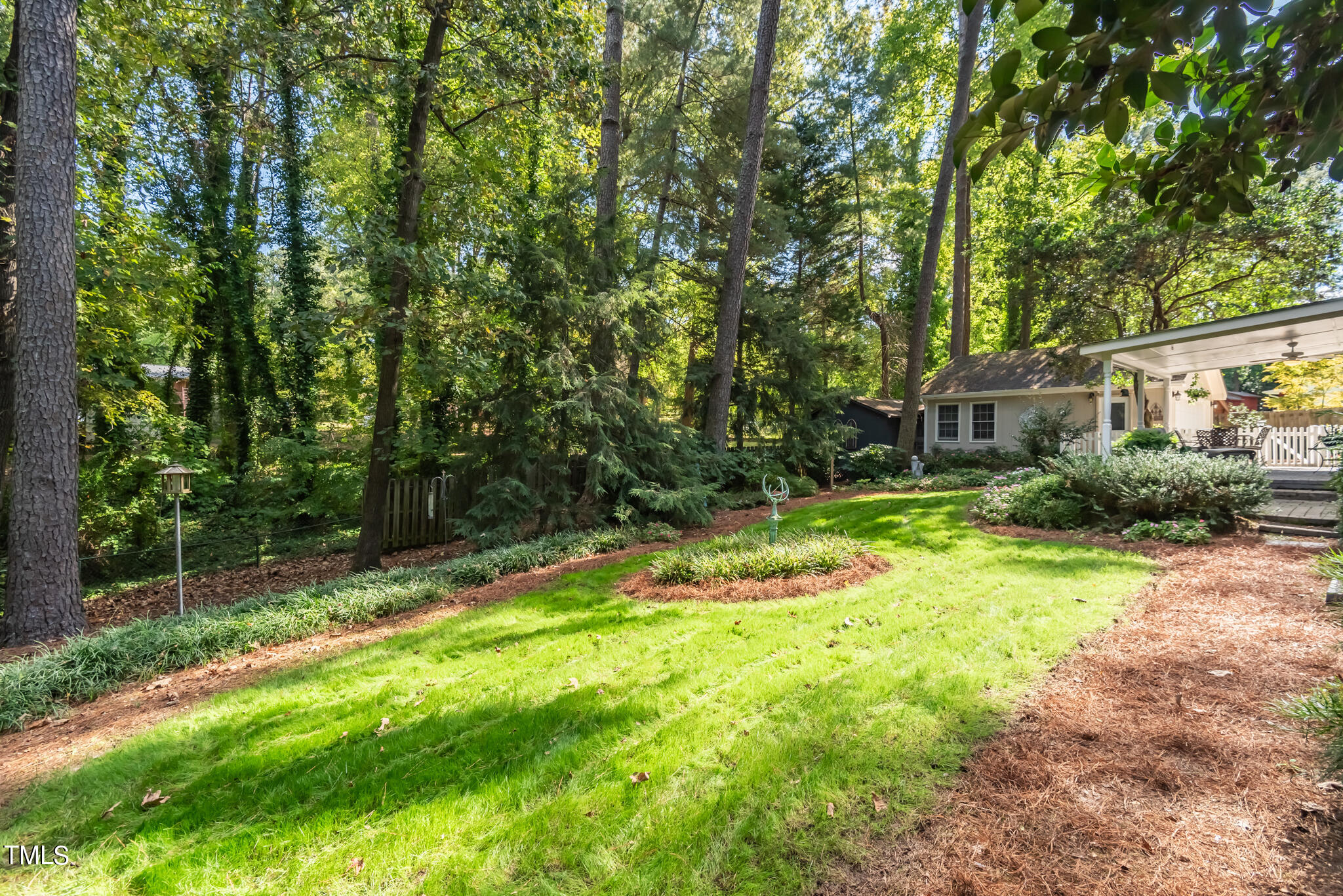 3404 Oates Drive Raleigh, NC 27604 - Photo 40 of 43 a backyard of a house with plants and large trees