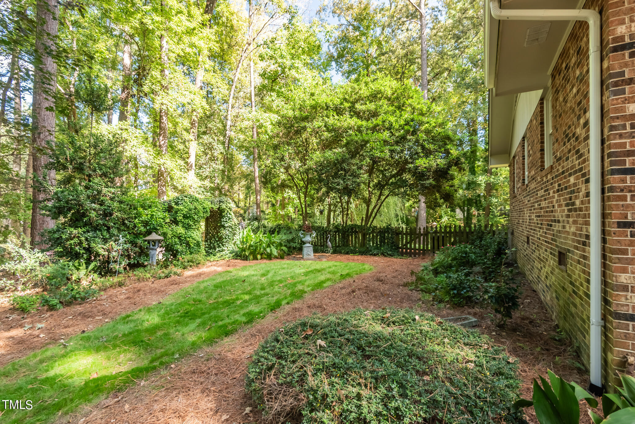 3404 Oates Drive Raleigh, NC 27604 - Photo 42 of 43 a view of a yard with plants and large trees