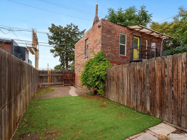 a view of a backyard with wooden fence