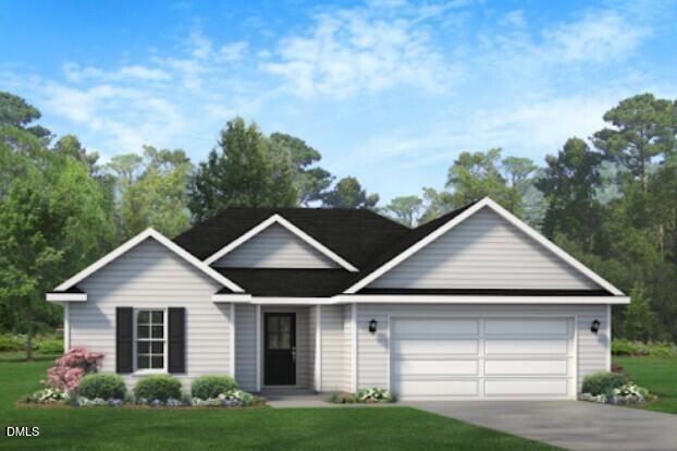 79 Ambrosia Way Bunnlevel, NC 28323 - Photo 2 of 3 a front view of a house with a yard and garage