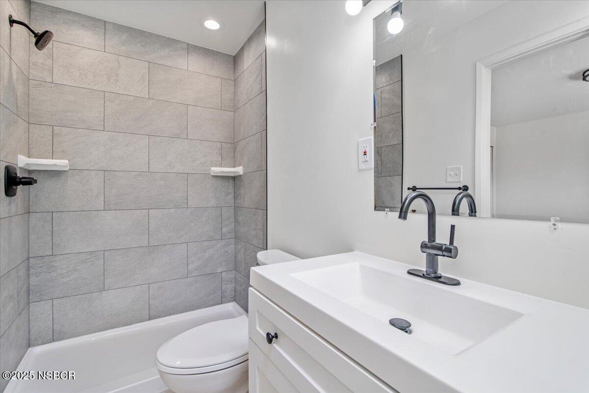 3446 Rucker Road Lompoc, CA 93436 - Photo 5 of 26 a bathroom with a sink a toilet and shower