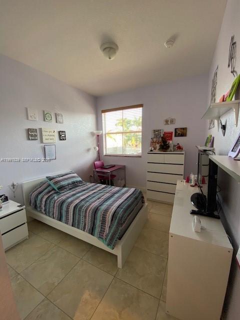 4920 Southwest 140th Terrace, Unit 4 Miramar, FL 33027 - Photo 12 of 15 a spacious bedroom with a bed and a window