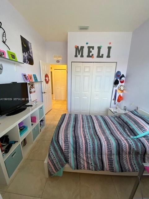 4920 Southwest 140th Terrace, Unit 4 Miramar, FL 33027 - Photo 13 of 15 a bedroom with a bed and flat screen tv