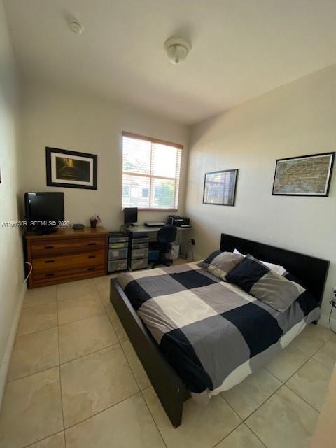 4920 Southwest 140th Terrace, Unit 4 Miramar, FL 33027 - Photo 14 of 15 a bedroom with a bed and wooden floor