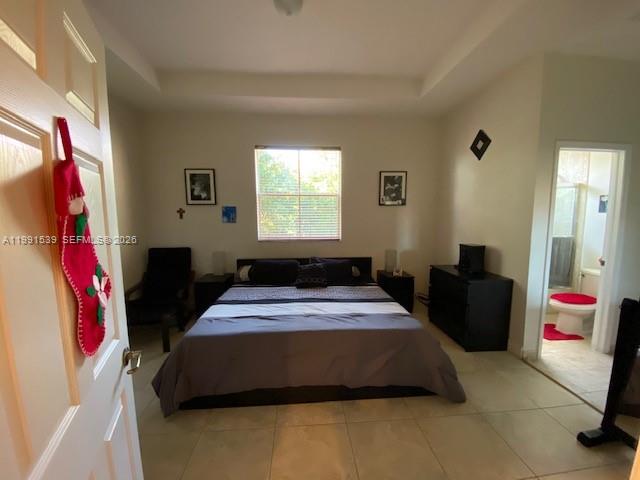 4920 Southwest 140th Terrace, Unit 4 Miramar, FL 33027 - Photo 8 of 15 a bedroom with a bed and a couch