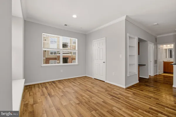 a view of empty room with wooden floor