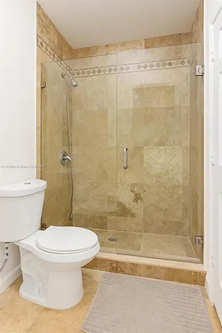 a bathroom with a toilet and shower