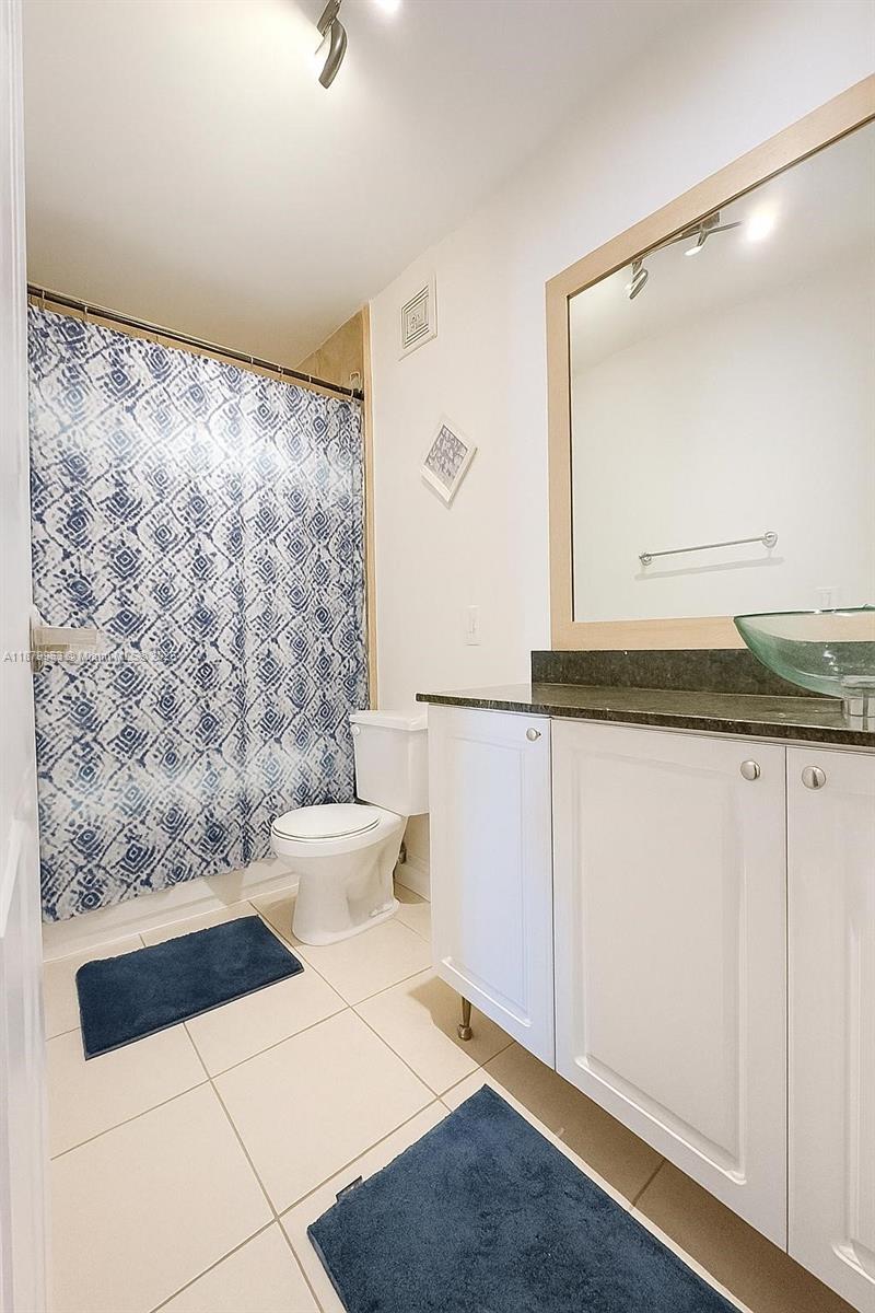 13781 Southwest 66th Street, Unit 221B Miami, FL 33183 - Photo 15 of 16 a bathroom with a sink and a mirror
