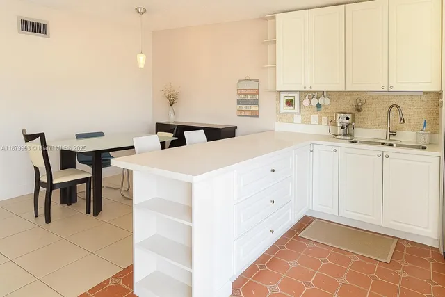 a kitchen with appliances cabinets and a sink