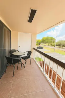 a view of a chairs and table in the balcony