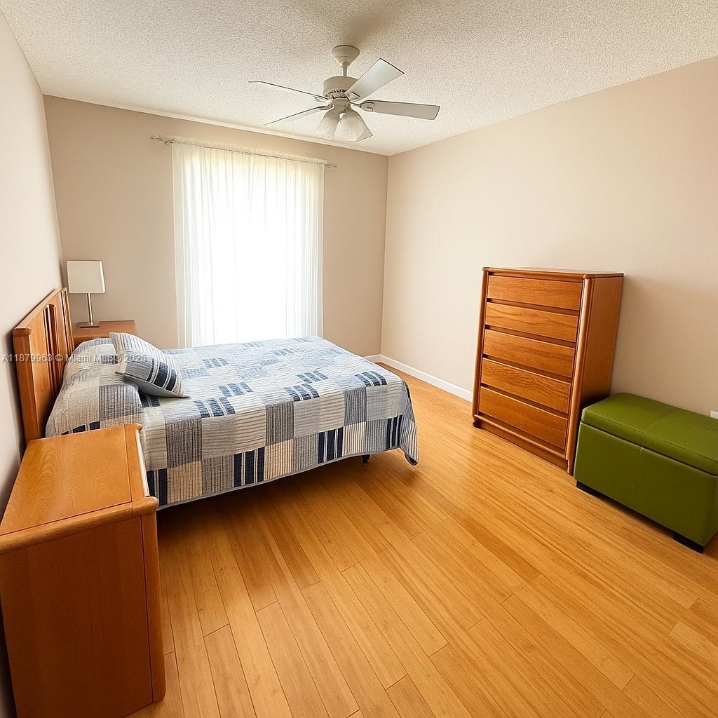 13781 Southwest 66th Street, Unit 221B Miami, FL 33183 - Photo 6 of 16 a bedroom with a bed and a chair