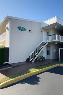 a view of swimming pool with yard in front of it