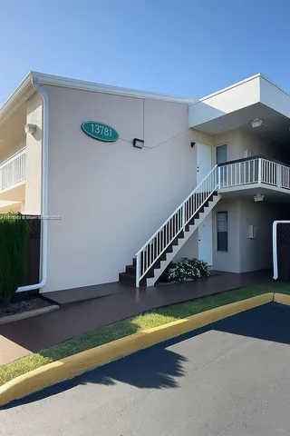 a view of swimming pool with yard in front of it