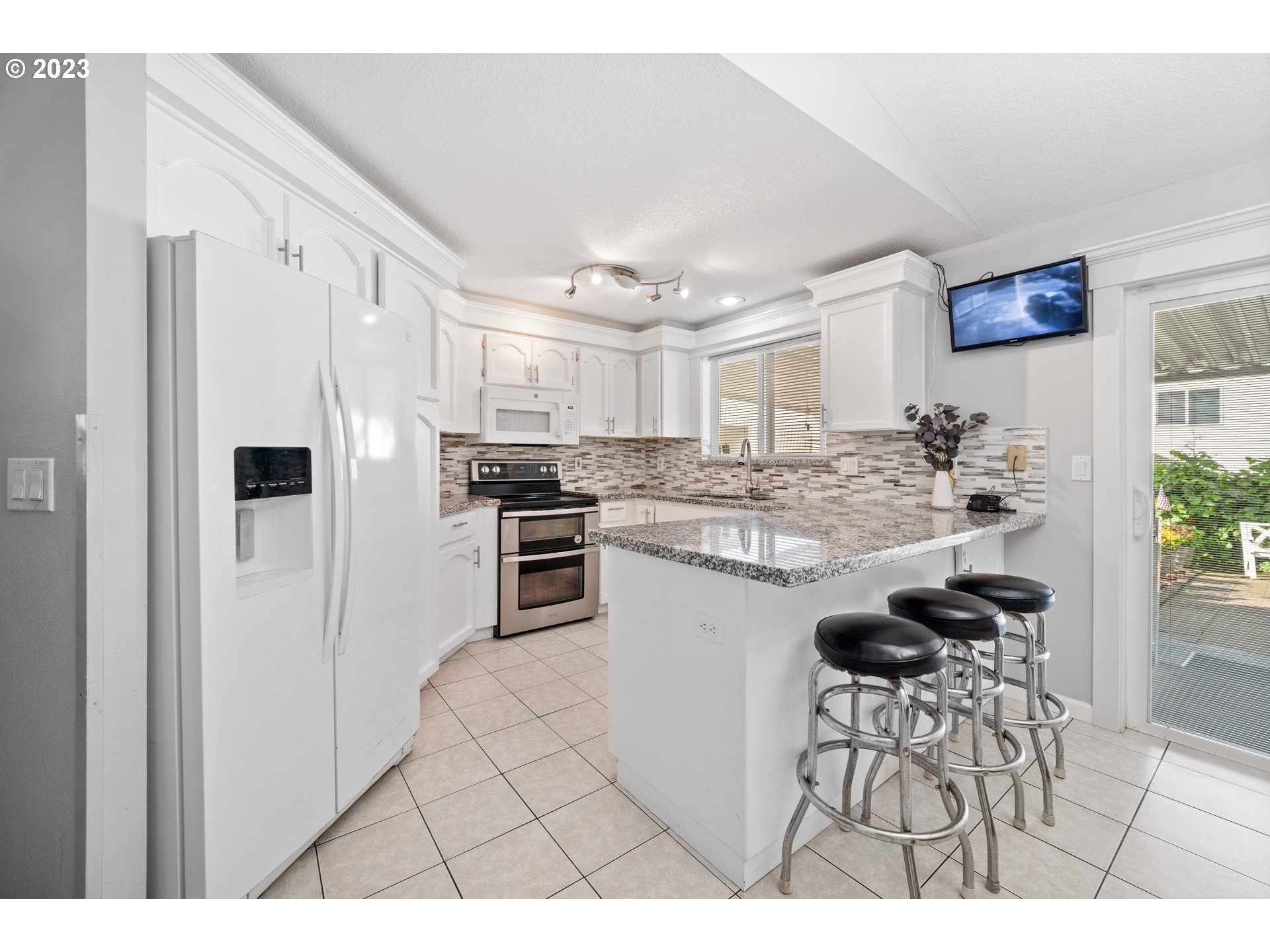 Undisclosed Address Vancouver, WA 98665 - Photo 6 of 16 a kitchen with stainless steel appliances kitchen island granite countertop a refrigerator and a stove top oven