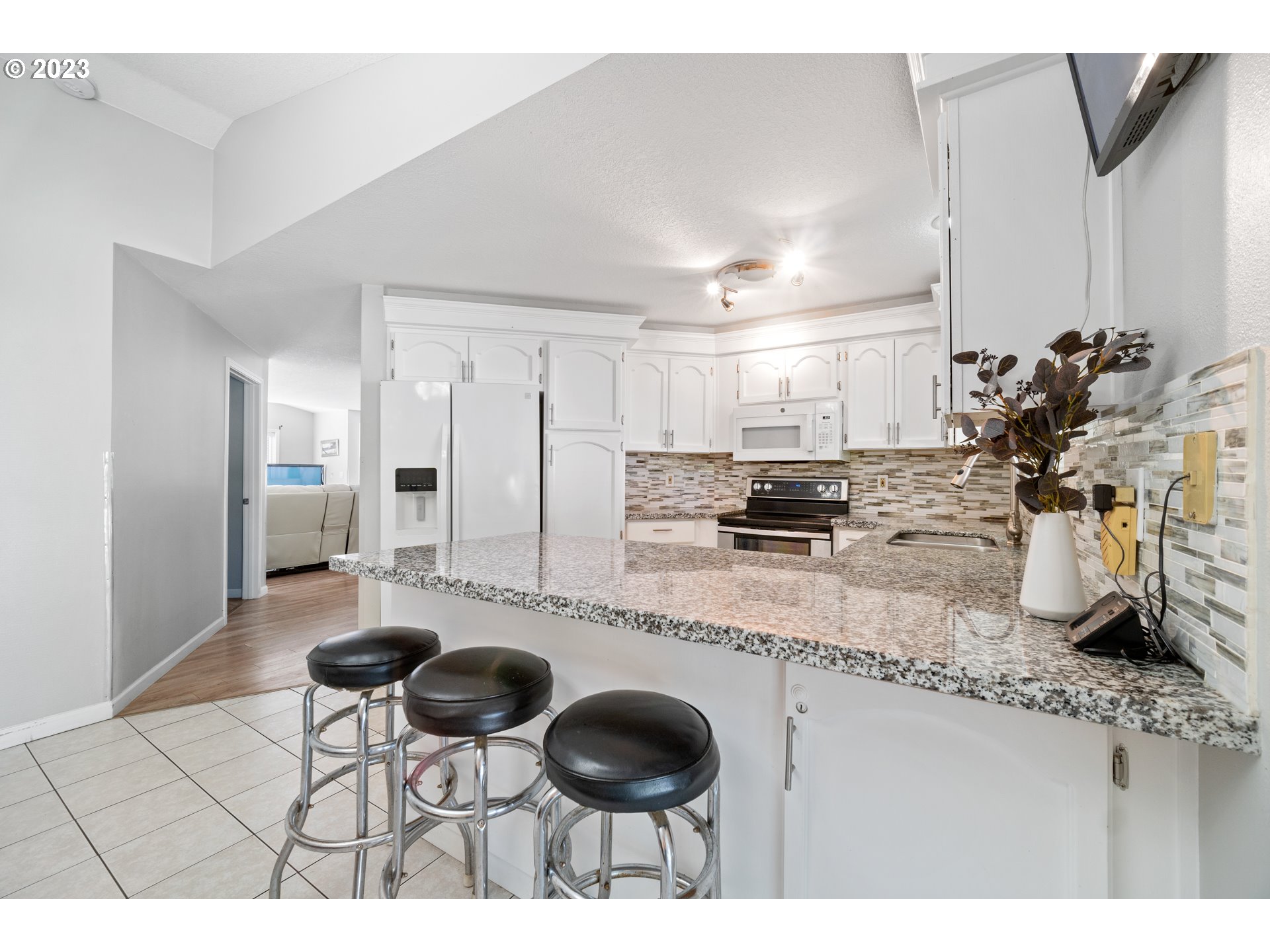 Undisclosed Address Vancouver, WA 98665 - Photo 7 of 16 a kitchen with stainless steel appliances kitchen island granite countertop a sink and cabinets