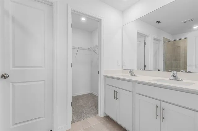 a bathroom with 2 sink and a mirror