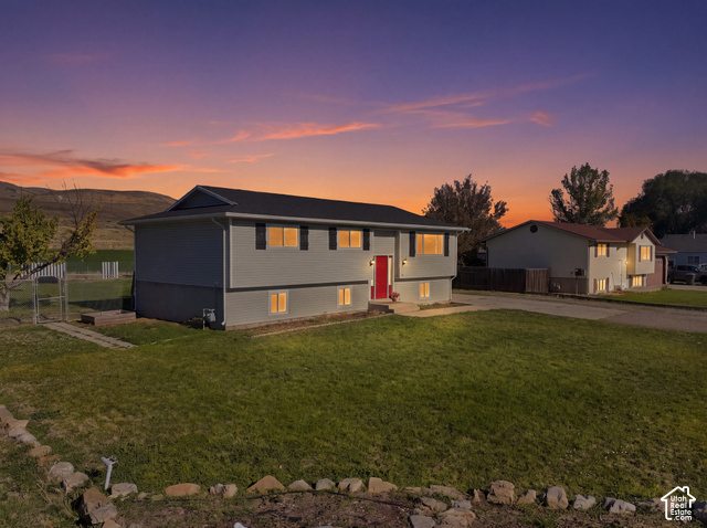 224 Canal Bank Road Garland, UT 84312 - Photo 21 of 21 Split-level residence featuring gray siding, a black shingle roof, and a red front door