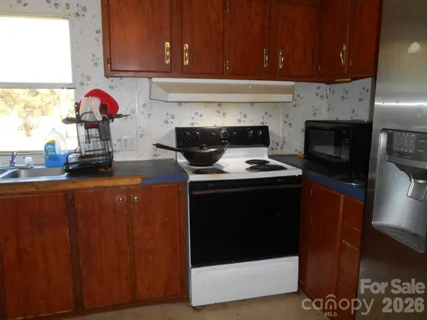 a kitchen with stainless steel appliances wooden cabinets and a stove