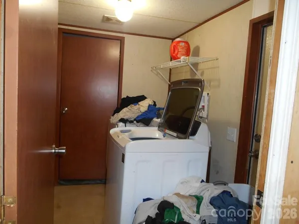 a bathroom with a sink vanity mirror and toilet