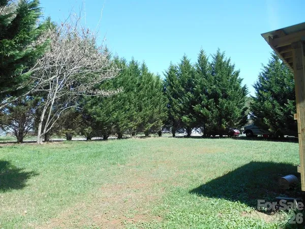 a view of a field with trees in the background
