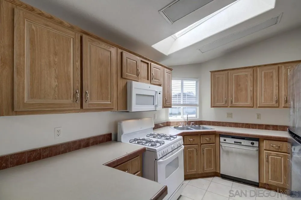 9902 Jamacha Boulevard, Unit 102 Spring Valley, CA 91977 - Photo 1 of 17 a kitchen with stainless steel appliances granite countertop a sink stove and refrigerator