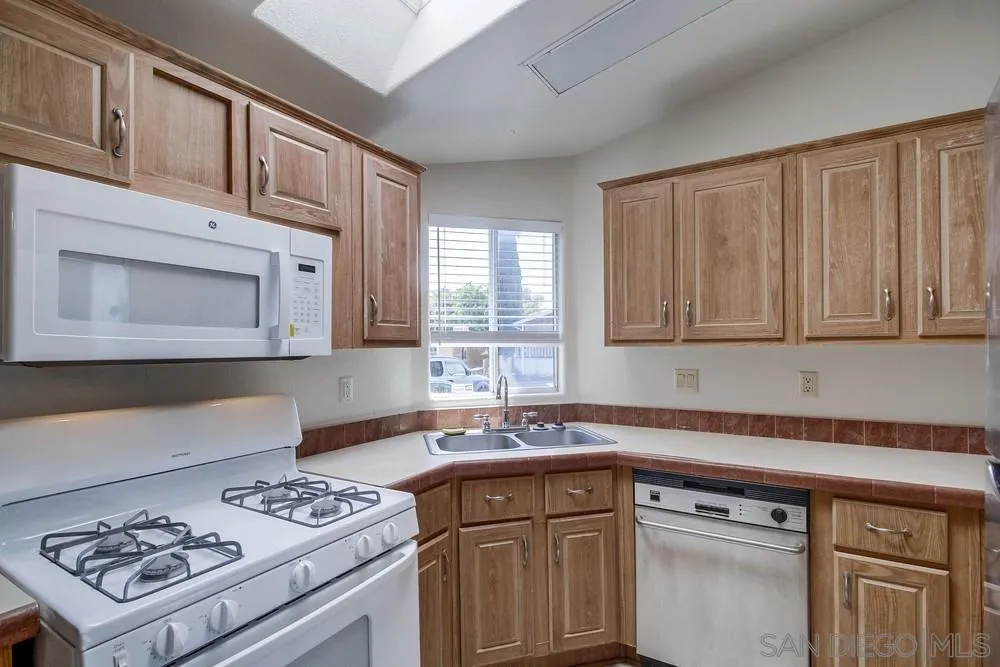 9902 Jamacha Boulevard, Unit 102 Spring Valley, CA 91977 - Photo 3 of 17 a kitchen with stainless steel appliances granite countertop a sink stove and cabinets