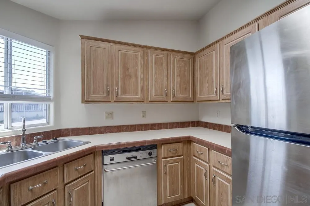 9902 Jamacha Boulevard, Unit 102 Spring Valley, CA 91977 - Photo 4 of 17 a kitchen with a sink cabinets and window