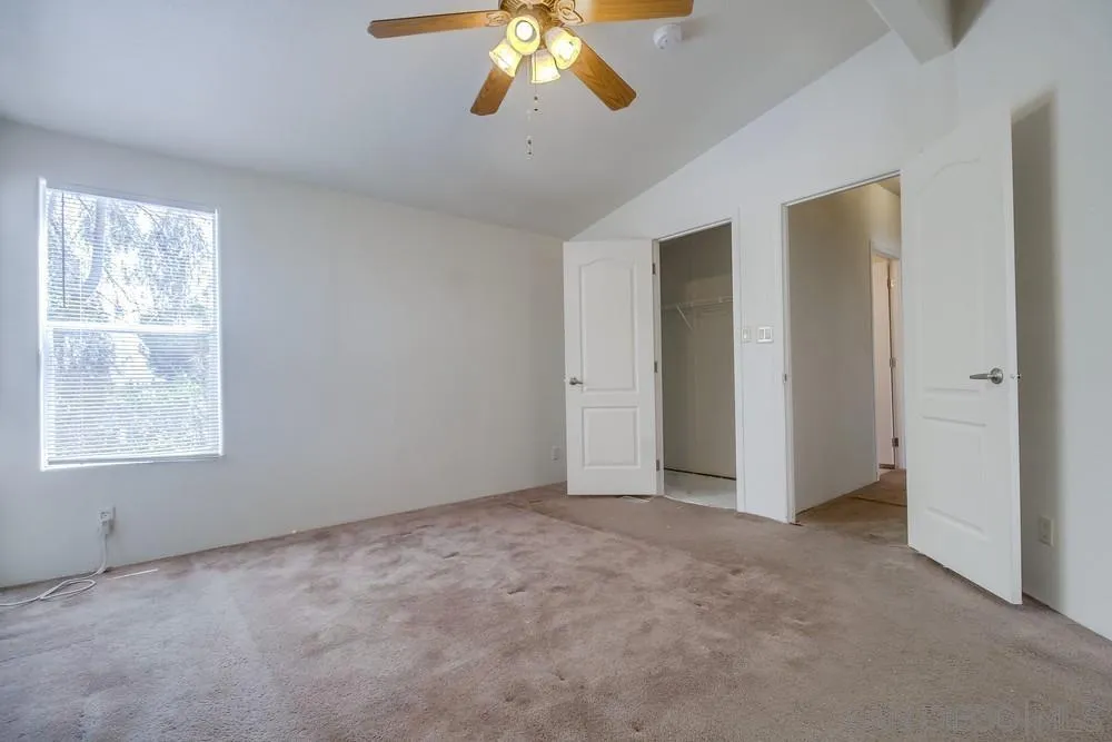 9902 Jamacha Boulevard, Unit 102 Spring Valley, CA 91977 - Photo 9 of 17 an empty room with windows and fan