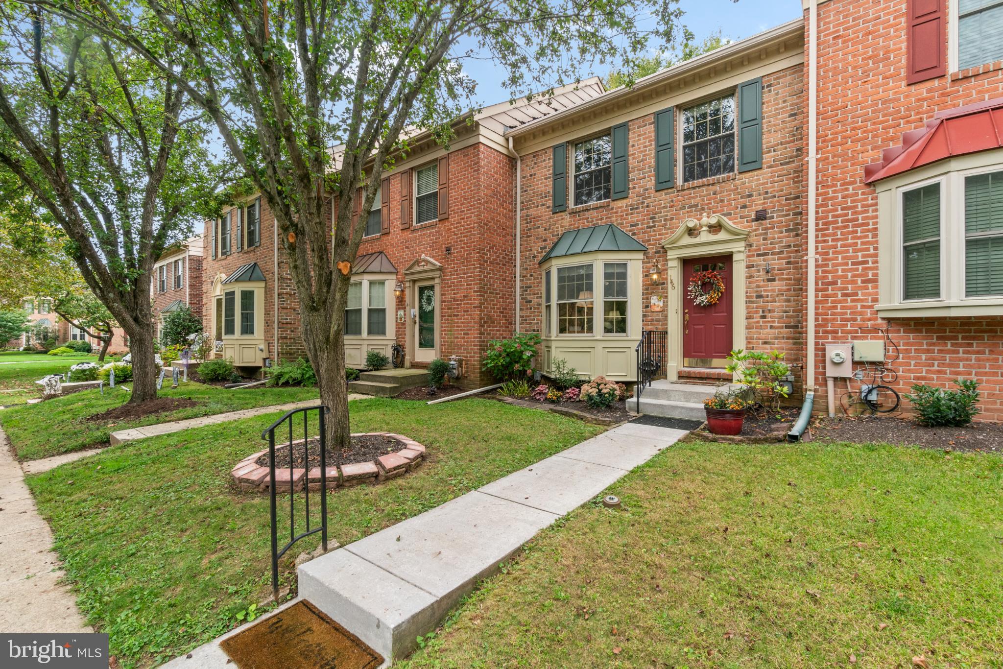 Charming brick townhome with inviting entrance.