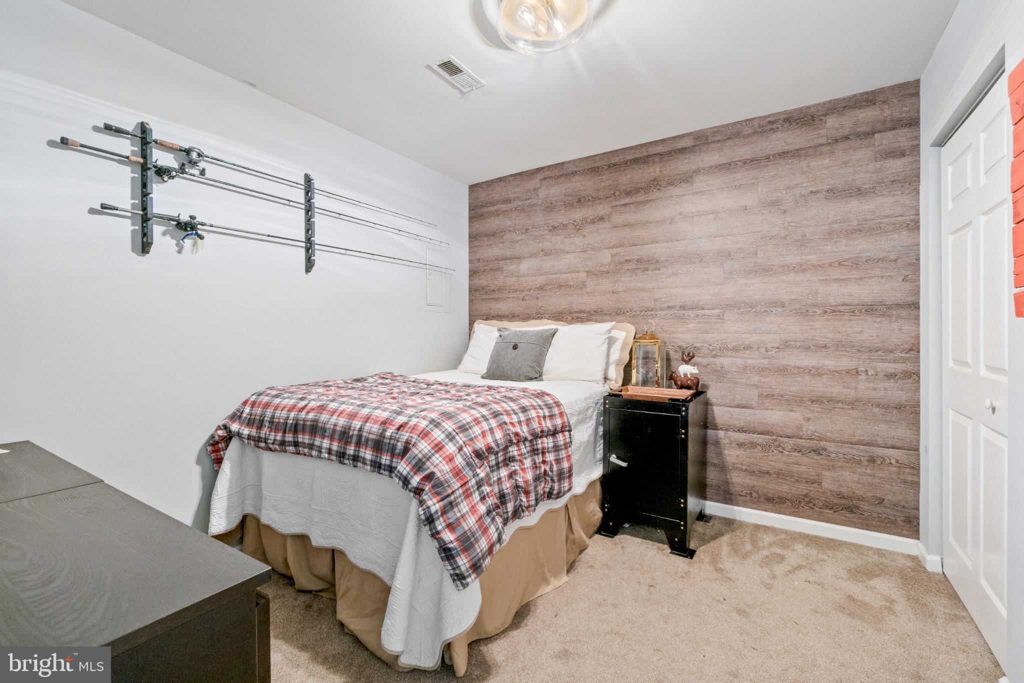 146 English Run Circle Sparks, MD 21152 - Photo 29 of 37 Cozy bedroom with rustic accent wall.