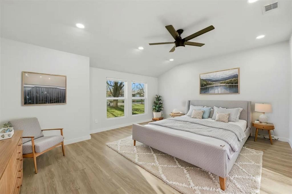 502 Madison Street Cleburne, TX 76033 - Photo 13 of 30 a bedroom with a large bed and a window