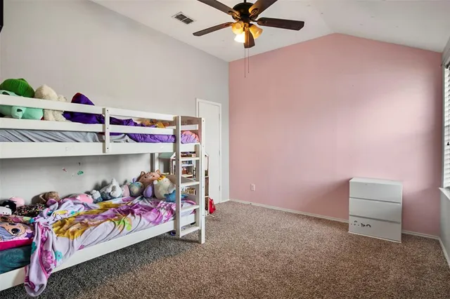 a bedroom with bed and a chandelier