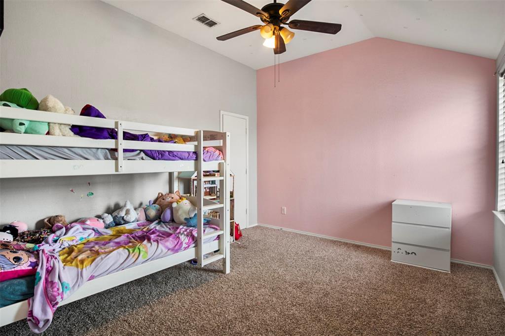 130 Cherrytree Trail Forney, TX 75126 - Photo 16 of 31 a bedroom with bed and a chandelier