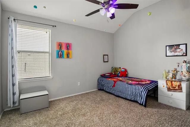 a living room with furniture and a baby crib