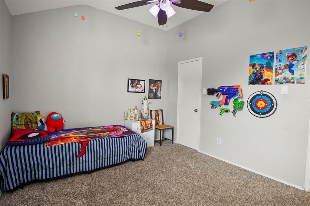 130 Cherrytree Trail Forney, TX 75126 - Photo 21 of 31 a bedroom with a bed and a chandelier