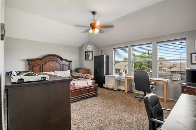 a bedroom with furniture and a large window