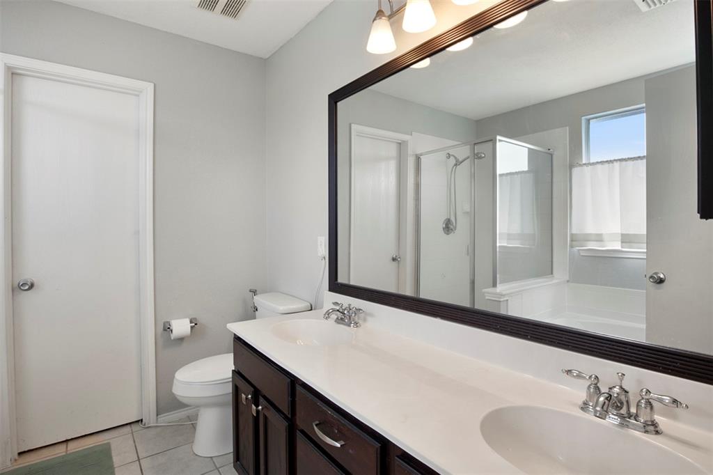 130 Cherrytree Trail Forney, TX 75126 - Photo 24 of 31 a bathroom with a sink a toilet and a mirror