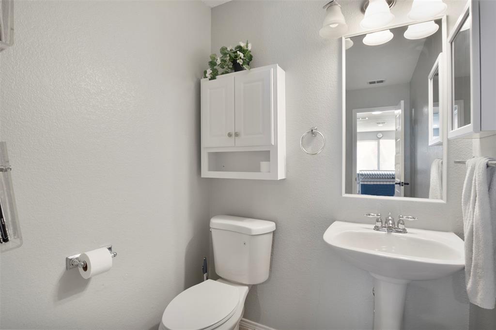130 Cherrytree Trail Forney, TX 75126 - Photo 6 of 31 a bathroom with a toilet sink and mirror