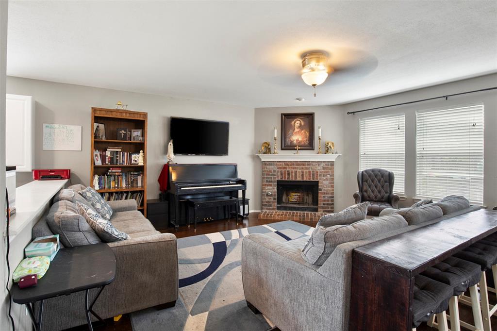 130 Cherrytree Trail Forney, TX 75126 - Photo 7 of 31 a living room with furniture a fireplace and a flat screen tv