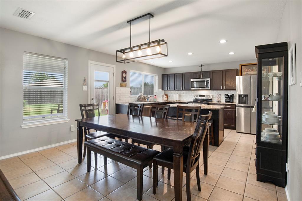 130 Cherrytree Trail Forney, TX 75126 - Photo 10 of 31 a large kitchen with a table and chairs