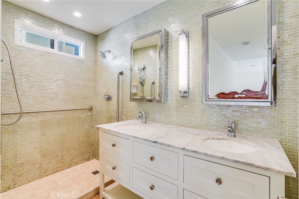 705 Iris Avenue Corona del Mar, CA 92625 - Photo 17 of 36 a bathroom with a granite countertop sink mirror and double